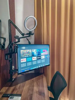 a computer monitor sitting on top of a wooden table at Olivia SOHO Guest House in Legian
