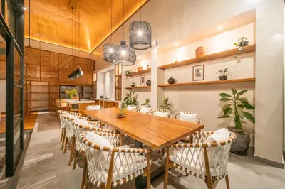a dining room with a wooden table and chairs at Villa Mango 2 - Amazing 4-bdr Villa in Berawa ! PERFECT LOCATION in Canggu