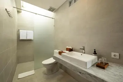 a bathroom with a sink and a toilet at Villa Christie By Nakula in Seminyak