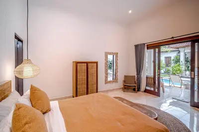 a bedroom with a bed and a sliding glass door at Villa Deba 3 by Bali Villa Solutions in Seminyak