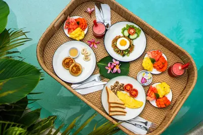 a tray of breakfast foods on a table at Villa Deba 3 by Bali Villa Solutions in Seminyak