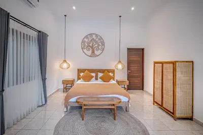 a bedroom with a large bed and a clock on the wall at Villa Deba 3 by Bali Villa Solutions in Seminyak