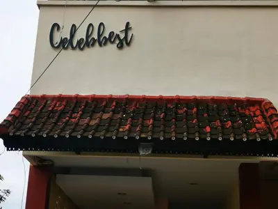 a sign on the side of a building at Celebbest in Kuta