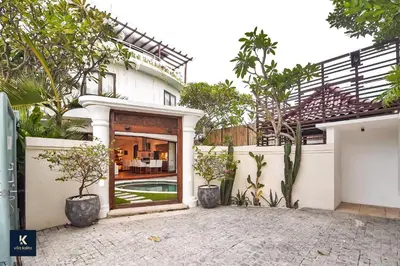 a house with a courtyard with a pool at Villa Kalita Bali in Seminyak