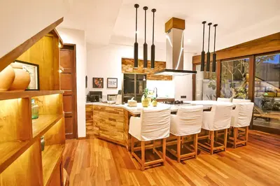 a kitchen with a large white table and chairs at Villa Kalita Bali in Seminyak