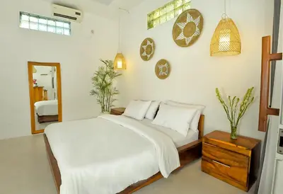 a bedroom with a bed and a table and a mirror at Villa Elijah in Seminyak