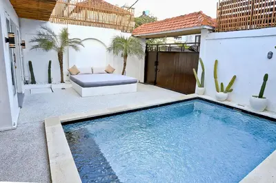 a swimming pool in the backyard of a house at Villa Elijah in Seminyak