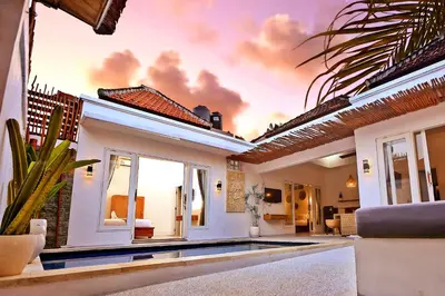 a villa with a swimming pool and a house at Villa Elijah in Seminyak