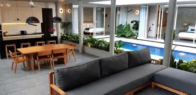 a living room with a couch and a table and a pool at Villa Mandja - Stunning architect-designed 3BR villa in Petitenget in Seminyak