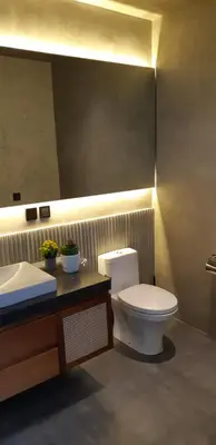 a bathroom with a toilet and a sink at Villa Mandja - Stunning architect-designed 3BR villa in Petitenget in Seminyak