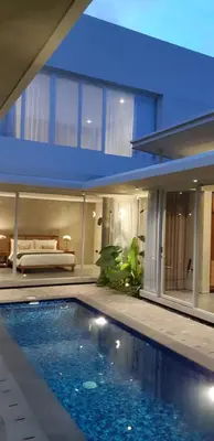 a house with a swimming pool in front of it at Villa Mandja - Stunning architect-designed 3BR villa in Petitenget in Seminyak