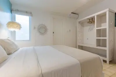 a white bedroom with a large bed and a window at Villa Madura DREAM 3bdrs Central Seminyak in Seminyak