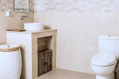 a bathroom with a toilet and a sink at Relax Bali Villas in Legian