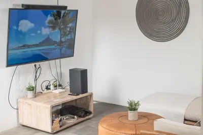 a living room with a flat screen tv on a wall at Relax Bali Villas in Legian