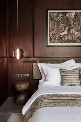 a bedroom with a bed and a painting on the wall at Munno Villa in Canggu
