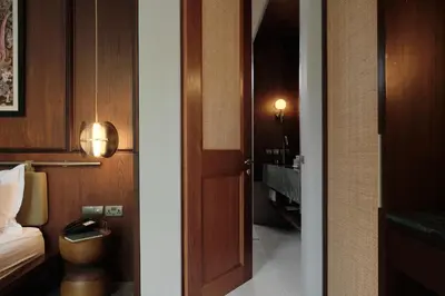 a room with a door and a room with a bed at Munno Villa in Canggu