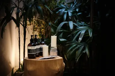 a table with bottles of wine and candles on it at Munno Villa in Canggu