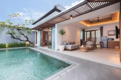 a swimming pool in a villa with a patio at Fenosa Seminyak Villas in Seminyak