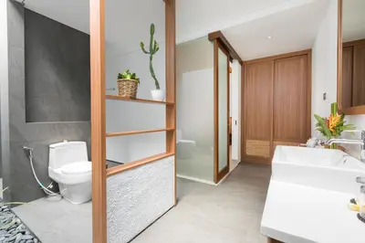 a bathroom with a toilet and a sink at Fenosa Seminyak Villas in Seminyak