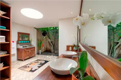 a bathroom with two sinks and a large mirror at Villa Andalas in Seminyak