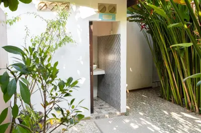 a bathroom with a sink and some plants at Jepun BnB Bali in Seminyak