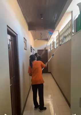 a woman is holding a kite in a hallway at Jepun BnB Bali in Seminyak