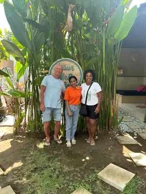 a group of people standing in front of a sign at Jepun BnB Bali in Seminyak