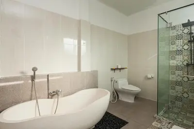 a white bathroom with a tub and a toilet at Maja Villa Batubelig by GenuineHost in Canggu
