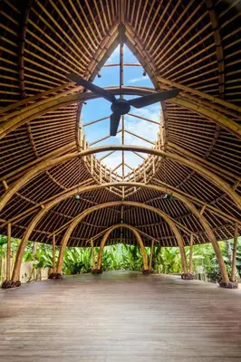 a large wooden building with a large clock in it at Umani Village in Kerobokan