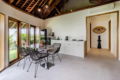 a kitchen and dining room with a table and chairs at Umani Village in Kerobokan