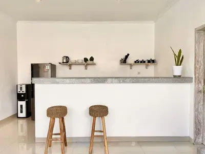 a bar with two stools in front of a counter at VILLA LUNA in Kerobokan