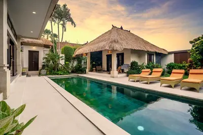 a villa with a swimming pool and a resort at Villa Gading by Alfred in Bali in Seminyak