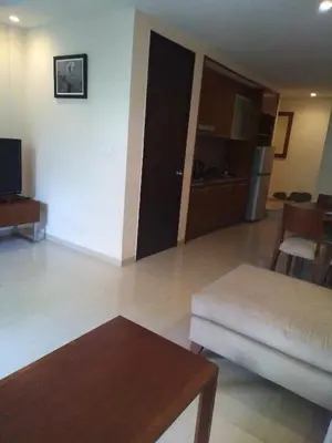 a living room with a couch and a table at LBV Seminyak Apartment in Seminyak