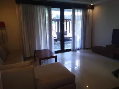 a living room with a couch and a table at LBV Seminyak Apartment in Seminyak