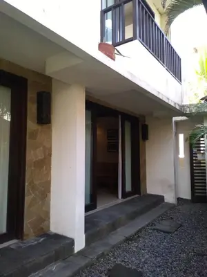 a house with stairs leading to a balcony at LBV Seminyak Apartment in Seminyak