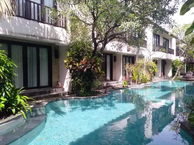 a swimming pool in front of a building at LBV Seminyak Apartment in Seminyak