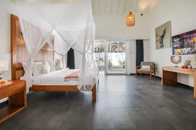 a bedroom with a bed with a mosquito net at Villa Zebra Walking Distance to Potato Head in Seminyak