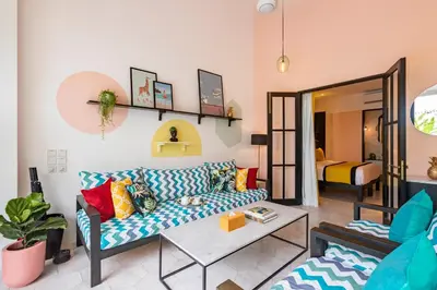 a living room with a couch and a table at Villa Caorrun Canggu in Canggu