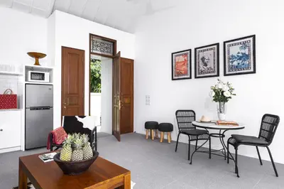 a kitchen and living room with a table and chairs at Villa Anahera Seminyak in Seminyak