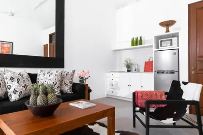 a living room with a black couch and a table at Villa Anahera Seminyak in Seminyak