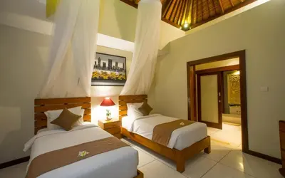 a bedroom with two beds and a mirror at Villa MD 3 bedroom, Sunny Pool in Eat st location in Seminyak