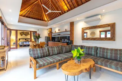 a living room with a couch and a table at Villa Kamboja Premium walk to double six Beach - enclosed living room with AC in Seminyak