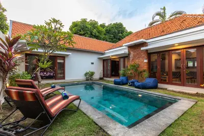 a swimming pool in the backyard of a house at Villa Kamboja Premium walk to double six Beach - enclosed living room with AC in Seminyak