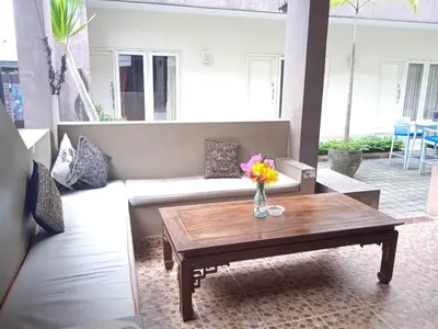 a living room with a couch and a coffee table at Gaing Mas Residence By Gaing Mas Group in Jimbaran