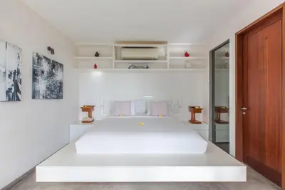 a white bedroom with a large white bed in it at AB Villa & Apartments in Seminyak
