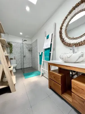 a bathroom with a sink and a mirror at Tiga Pantai Villa Legian in Legian