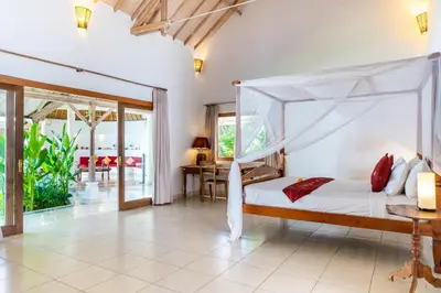 a bedroom with a bed with a canopy at Villa Damai Kecil Seminyak by Adam Jyota Management in Seminyak