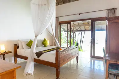 a bedroom with a bed with a canopy at Villa Damai Kecil Seminyak by Adam Jyota Management in Seminyak