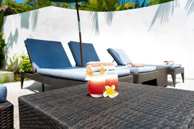 a table with two drinks and a flower on it at Villa Damai Kecil Seminyak by Adam Jyota Management in Seminyak