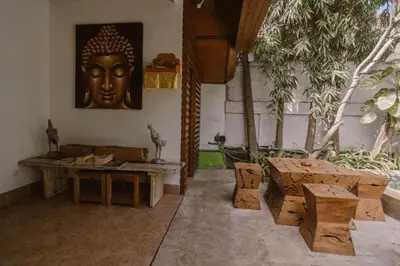 a room with a statue of a head on the wall at Bale Seminyak in Seminyak